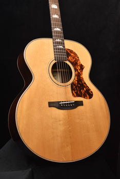 jumbo acoustic guitar front view with natural body, tortoise-pattern pickguard, rosette