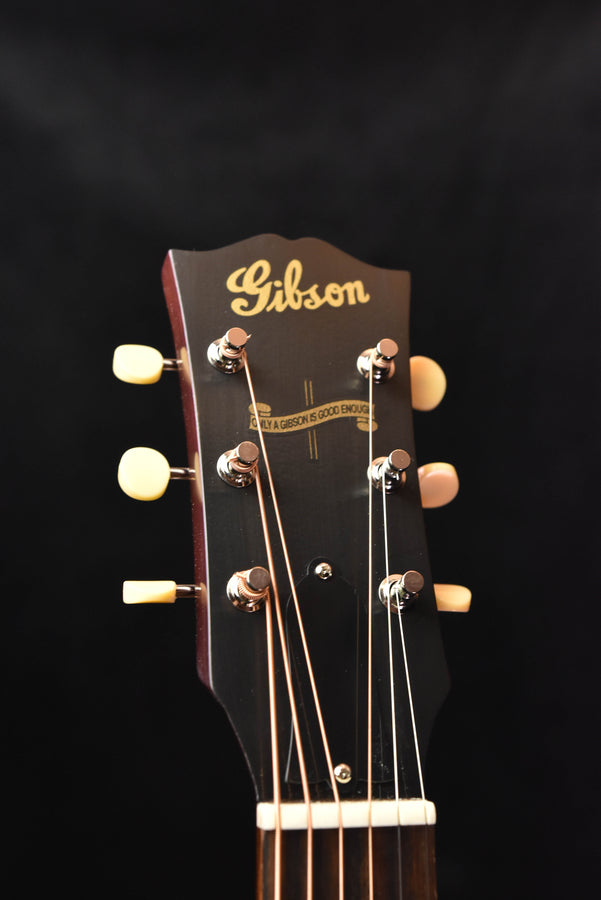 Gibson acoustic guitar headstock with tuning pegs and logo