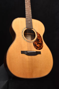 natural acoustic guitar body with decorative soundhole ring and black bridge