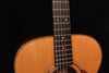Close-up of acoustic guitar fretboard with dot markers and rosette edge
