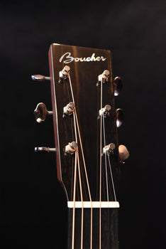 acoustic guitar headstock with boucher logo and chrome tuning machines