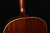Acoustic guitar upper bout with glossy wood finish and gold binding