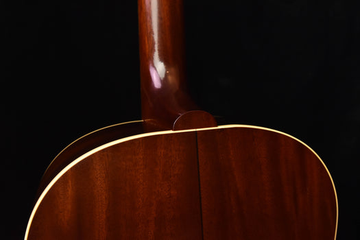 acoustic guitar upper bout with glossy wood finish and gold binding