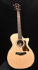 Natural wood acoustic guitar with black pickguard and circular soundhole rosette