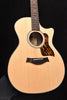 Natural wood acoustic guitar front view with black pickguard and soundhole rosette
