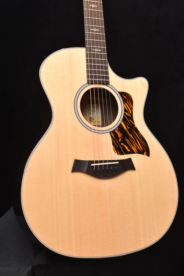 Natural wood acoustic guitar front view with black pickguard and soundhole rosette