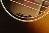 J-45 acoustic guitar volume and tone controls on black pickguard, sunburst body