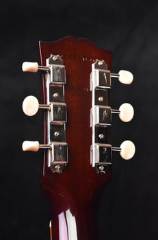 j-45 acoustic guitar headstock with tuners and white knobs, rear view