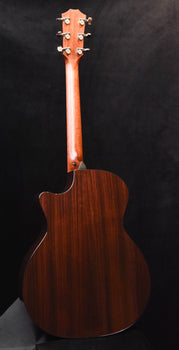 dark wood acoustic guitar back with curved body shape and side binding