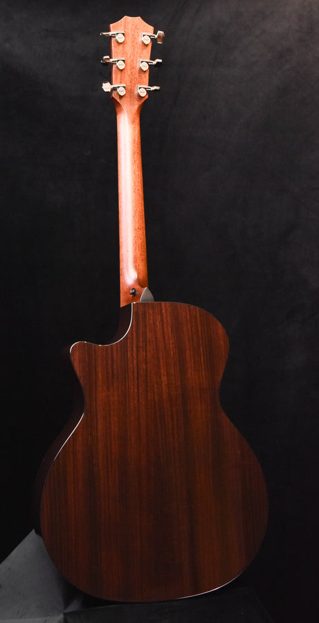 Dark wood acoustic guitar back with curved body shape and side binding