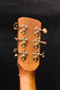 Acoustic guitar headstock rear with gold tuning machines and mounting hardware