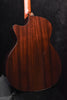 Dark wood acoustic guitar back view with prominent grain and rounded shoulder