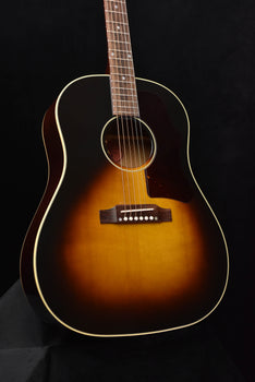 sunburst acoustic guitar body with bridge, soundhole, and cream binding