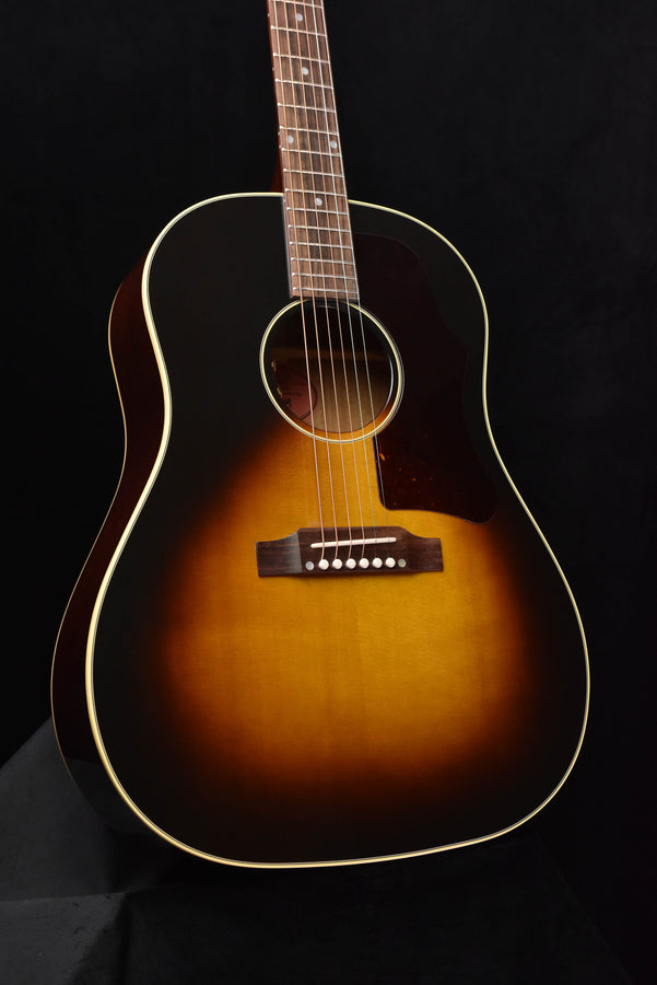 Sunburst acoustic guitar body with bridge, soundhole, and cream binding