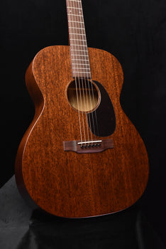 martin acoustic guitar front view with sunburst body, soundhole, and bridge