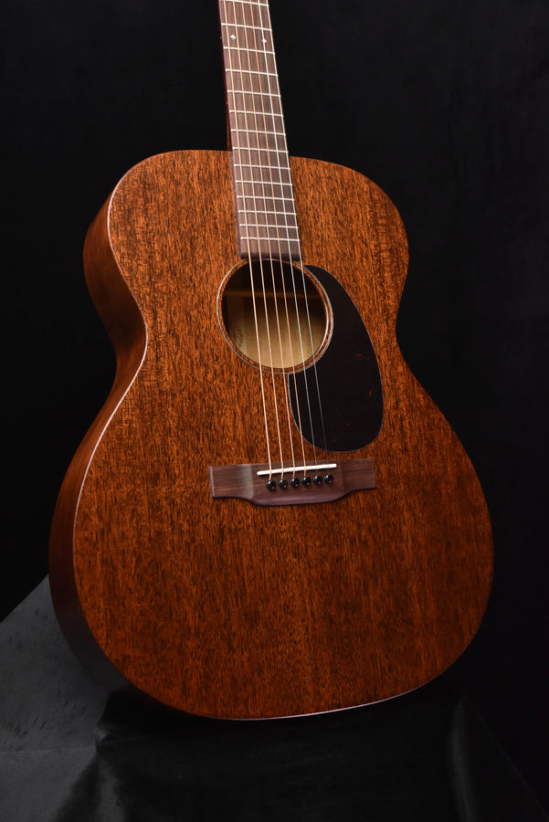 Martin acoustic guitar front view with sunburst body, soundhole, and bridge