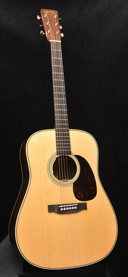 Dreadnought acoustic guitar with natural wood finish and round sound hole