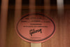 Gibson label inside soundhole with text and serial number on wood