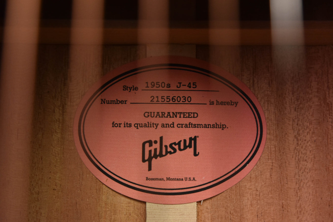 Gibson label inside soundhole with text and serial number on wood