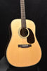 Natural dreadnought acoustic guitar with black pickguard and bridge with controls