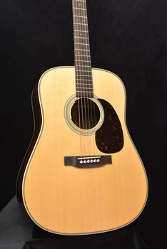 natural dreadnought acoustic guitar with black pickguard and bridge with controls