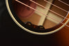 Acoustic guitar soundhole with volume and tone control labels