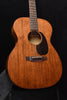 Martin acoustic guitar front with dark pickguard and bridge with strings