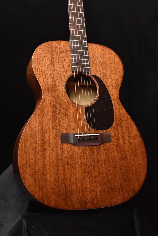 Martin acoustic guitar front with dark pickguard and bridge with strings
