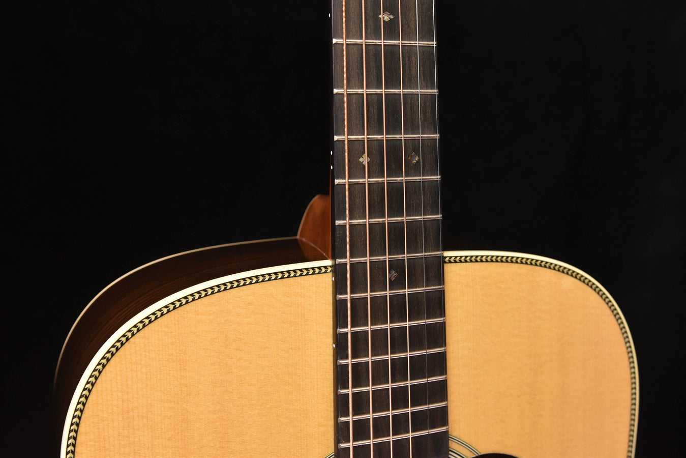 Acoustic guitar neck and upper body with fretboard and sound hole edge detail