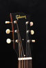Gibson acoustic guitar headstock with gold logo and chrome tuning machines