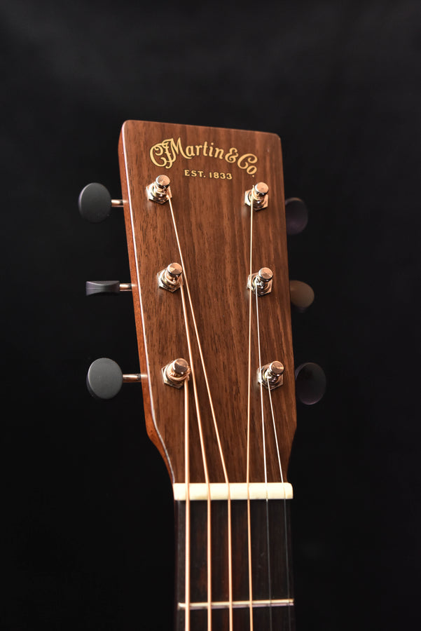 Martin acoustic guitar headstock with tuning pegs and engraved logo
