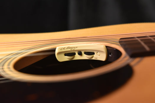 anthem pickup control module on acoustic guitar top with vu-style indicators