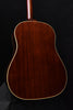 Close-up of acoustic guitar back with wood grain and cream edge binding