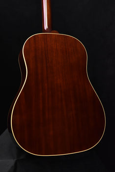 close-up of acoustic guitar back with wood grain and cream edge binding