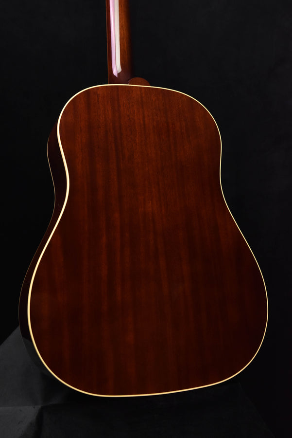Close-up of acoustic guitar back with wood grain and cream edge binding