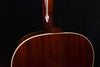 Acoustic guitar neck joint above the soundboard with glossy dark wood finish
