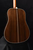 Full view of acoustic guitar back with natural wood finish and binding outline