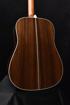 full view of acoustic guitar back with natural wood finish and binding outline