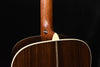 Acoustic guitar neck joint area with strap button and dark wood top binding
