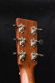 martin acoustic guitar headstock with six tuning pegs and string posts
