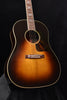 Acoustic jumbo guitar front with soundhole, bridge, and sunburst finish