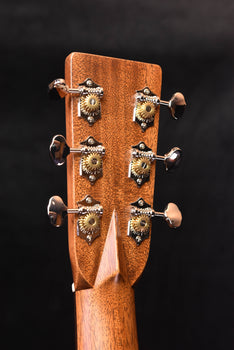 acoustic guitar headstock with tuning machines and glossy wood texture finish