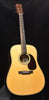 Signature dreadnought acoustic guitar with natural wood body and black pickguard