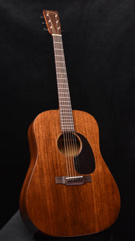 brown dreadnought acoustic guitar body with black pickguard and round sound hole