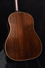 Acoustic guitar back close-up with wood grain and gold binding outline
