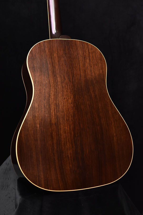 Acoustic guitar back close-up with wood grain and gold binding outline