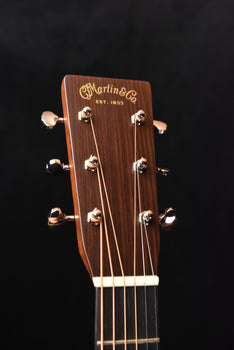 martin headstock on a signature acoustic guitar with tuning pegs and logo