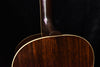 Acoustic guitar back close-up with glossy finish and gold binding line