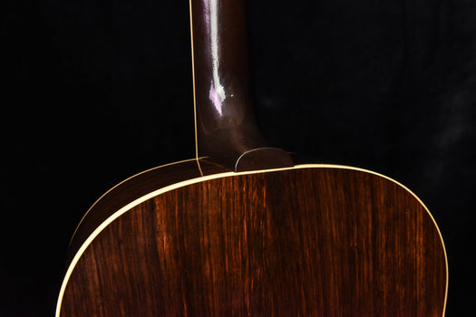 acoustic guitar back close-up with glossy finish and gold binding line