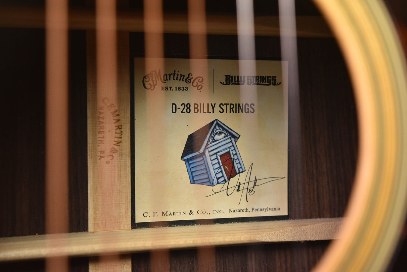 Acoustic guitar interior label reading D-28 Billy Strings on the soundboard